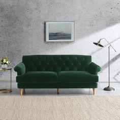 a living room with a green couch and two lamps on either side of the couch