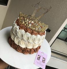 there is a cake that has been decorated with gold and white icing on it