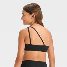 Make a versatile addition to your child's swim closet with the "Stay a While" Solid Bikini Swim Top from art class™. This solid-color swim top features a one-shoulder design with two straps at the back for a beautiful look. Providing four-way stretch, this ribbed bikini swim top offers the right flexibility for watery adventures, and is fun to mix and match with swim bottoms. Plus, they'll stay shielded from the sun's rays with the UPF 50+ rated fabric. Welcome to art class™, where style is what Black Summer Beachwear Swimwear, Black Stretch Swimwear For Play, Top Art, Fabric Tape, Shoulder Design, Swim Bottoms, Pair Of Pants, Swim Top, Art Class