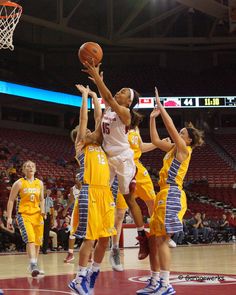 the girls are playing basketball on the court