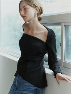 This product is a Square Neck Tulip Blouse that combines a structured square neckline with the soft, flowing lines of a tulip-shaped body, offering a blend of geometric and organic design elements. The blouse features a fitted waist that accentuates the silhouette, while the peplum detail adds a touch of drama and femininity to the overall aesthetic. Crafted to provide a sophisticated and polished look, this piece is perfect for both formal and casual settings. - The blouse boasts a square neckline that frames the collarbones and lends a modern edge.- A peplum waist creates a flattering tulip-like silhouette that enhances the garment's elegance.- The long sleeves add a traditional touch, balancing the contemporary neckline and fitted bodice.- Constructed with a blend of materials that Formal Off-shoulder Tops For Fall, Evening Tops With Structured Shoulders And Long Sleeves, Long Sleeve Tops With Structured Shoulders For Evening, Modern Fall Blouse For Night Out, Party Tops With Structured Shoulders And Long Sleeves, Modern Blouse For Fall Night Out, Modern Blouse For Night Out In Fall, Fitted Long Sleeve Top With Structured Shoulders, Long Sleeve Tops With Structured Shoulders For Party