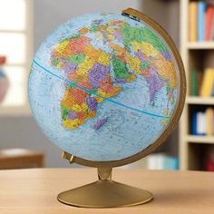 a globe on a table with books in the background