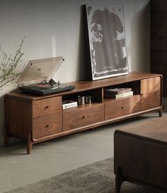 a record player sitting on top of a wooden cabinet