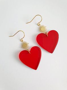 Beautiful pair of red heart earrings. These earrings are designed for pierced ears and made with see through red acrylic heart charm (31mm x 31mm) and a brass gold sun shaped connector (18mm x 13mm). Total length (50mm approx)  They come in an organza bag ready for gift giving. If you have any questions regarding shipping and payment, please take a look at my shop policies: http://www.etsy.com/uk/shop/LadyMangoJewellery/policy?ref=shopinfo_policies_leftnav ● Shipping: For customers in the UK you Red Heart-shaped Single Earring, Single Red Heart-shaped Earring, Red Heart Single Earring For Valentine's Day, Red Single Heart Earring For Valentine's Day, Red Double Heart Pierced Earrings, Red Pierced Heart Earrings As Gift, Red Heart Dangle Earrings, Gold Sun Earrings, Big Earrings Gold