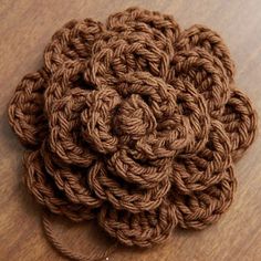 a crochet flower on a wooden surface