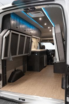 the interior of a white van with its doors open and cabinets in place for storage