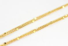 Two strands of tiny twinkling gold bars set on rich 24k gold plated chains drape gracefully together to create this mesmerizing dainty anklet, perfect for layering. This anklet is adjustable between 9 - 11 inches long. The second strand is 0.5 inches longer than the first. The 1.7mm 24k gold plated chains are finished with a 24k gold plated lobster claw clasp. One Strand Starlit Gold Anklet: https://www.etsy.com/listing/678969028/starlit-gold-anklet-dainty-gold-chain Three Strands Starlit Gold A Adjustable Gold Anklets With Satellite Chain, Gold Chain Anklets As Gift, Gold Anklets With Satellite Chain As Gift, Gold Anklet With Satellite Chain For Gift, Gold Chain Anklet Gift, Gold Anklets With Satellite Chain, Gold Anklet With Chain Design For Gift, Dainty Gold Anklet With Delicate Chain, Gold Plated Adjustable Chain Anklets