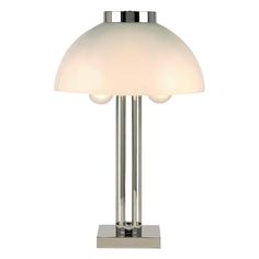 a lamp that is sitting on top of a metal stand with two lights in front of it