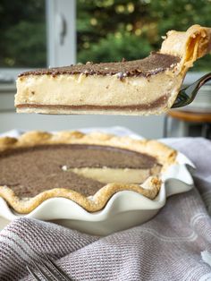 a piece of pie being lifted from a pie dish