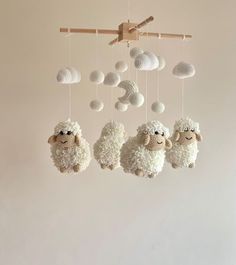 three sheep mobiles hanging from the ceiling