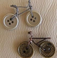 three buttons attached to the side of a bike wheel on a white sheeted surface