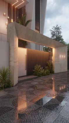 the entrance to a modern home with plants and lights on it's side wall