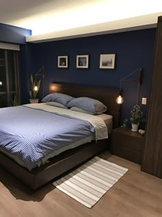 a bedroom with blue walls and wooden floors