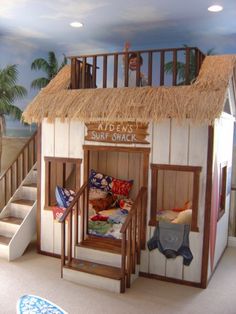 a kid's bedroom with a bunk bed and stairs leading to the second floor