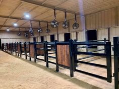 an empty stable with several stalls and lights