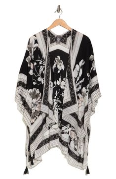 Vivacious floral printing blooms across a lightweight ruana featuring dramatic wide sleeves for an ultrachic, layered look. 40" length 100% rayon Hand wash, dry flat Imported Model stats: 5'10" height, 32" bust, 25" waist, 36" hip. Model is wearing size One Size. Spring Printed Wrap Kaftan, Spring Floral Print Chic Kaftan, Chic Floral Print Spring Kaftan, Chic Floral Print Kaftan For Spring, Chic Floral Print Kimono For Daywear, Chic Printed Kaftan For Spring, Spring Floral Print Wrap Kaftan, Spring Floral Wrap Kaftan, Spring Bohemian Viscose Kaftan