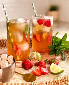 two glasses of iced tea with strawberries and lime