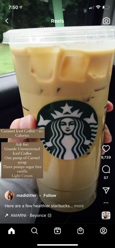 someone is holding up a cup of iced coffee in their hand, with information about the drink