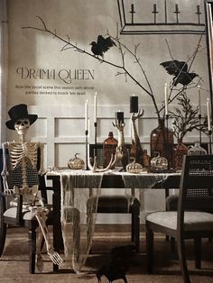 a table with candles and skeleton decorations on it