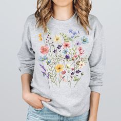 Our wildflower sweatshirt makes a perfect gift for your teacher,mom,wife,friend and of course yourself! -These sweatshirts are Unisex Adult Sizing (not women's fitted sweatshirt ). If you're going for a more fitted look, we suggest to size down.Please use the measurements chart in the pictures section to determine your correct size. -Props used In photos  are NOT included with purchase. -Care Instructions: Wash inside out in cold water, gentle cycle, tumble dry low or let air dry. Do not iron on Multicolor Tops For Spring As A Gift, Floral Print Relaxed Fit Tops As Gift, Long Sleeve Cotton T-shirt With Floral Print, Cotton Tops With Plants Print For Gift, Cotton Tops With Plant Print For Gifts, Cotton Tops With Plant Print As Gift, Cotton Tops With Plant Print, Spring Casual Tops As Gift, Floral Print Spring Sweatshirt