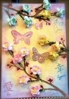 some flowers and butterflies are on a piece of paper that is laying on a table