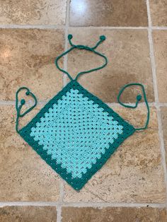 a crocheted square sitting on the floor