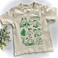 Nature Lover Toddler Shirt | Outdoors Apparel | Frog Toad Mushroom Explore Adventure Nature Shirt | Kids Cute T shirt | Hippie | Free Range by TinyNative on Etsy Outdoor Tshirt Design, White Cotton Tops With Mushroom Print, Cotton Short Sleeve Shirt With Mushroom Design, Nature Shirt Design, Toad Mushroom, Summer Graphic Tee With Mushroom Design, Earth T Shirt Design, Green Cotton Nature-inspired T-shirt, Green Nature-inspired Cotton T-shirt