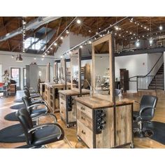 a salon with lots of chairs and lights on the ceiling is shown in this image