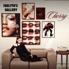 a woman sitting on top of a couch in front of posters