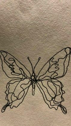 a drawing of a butterfly sitting on top of a piece of paper with black ink