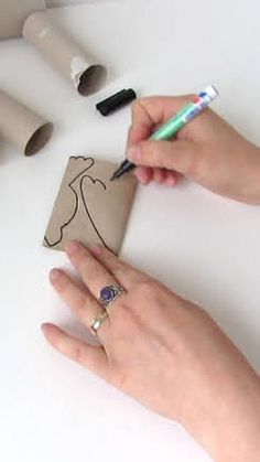 two hands are drawing on a piece of paper