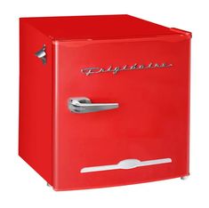 a red refrigerator sitting on top of a white floor next to a metal handle and door