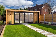 a garden room with sliding glass doors on the outside and grass in the front yard