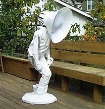 a statue of a man with a white hat on top of it's head