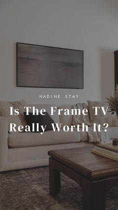 a living room filled with furniture and a large painting on the wall above it that says, is the frame tv really worth?