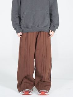 This is a trendy and minimal pants by FUTURE LAB that is made out of high quality and sturdy material. With distinctive mood of the design and comfortable wear, you can style it for your casual daily outfit.- Elastic waistband with string- Unique vertical taping and seams detail- Embroidery detail on the left leg Brown Fall Bottoms For Streetwear, Brown Wide Leg Pants For Streetwear, Wide Leg Brown Pants For Streetwear, Brown Cotton Parachute Pants For Fall, Baggy Brown Long Pants, Fall Brown Cotton Parachute Pants, Baggy Brown Ankle Pants, Baggy Brown Sweatpants With Pockets, Baggy Brown Bottoms For Streetwear