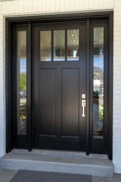 a black front door with two sidelights