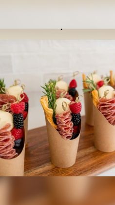 four small cups filled with different types of food