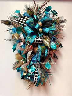 a wreath with peacocks and feathers hanging on the wall