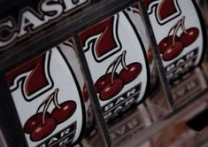 several slot machines with cherries on them are shown in close up view to show the number seven