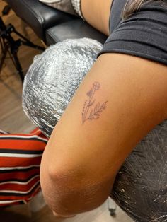 a woman with a flower tattoo on her arm