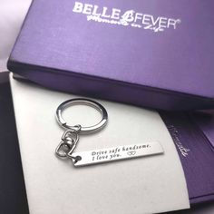 a purple box with a silver keychain on top of it that says, believe forever