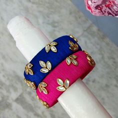 two different colored rings sitting on top of each other