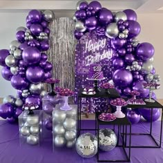 a purple and silver birthday party with balloons