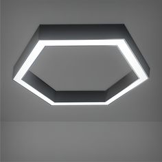 a modern ceiling light with an octagonal shape in the center and white lighting above it