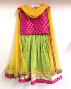 Girls brocade and chiffon lehenga in pink and lime green with yellow highlights Party Green Choli With Pallu Details, Party Wear Green Choli With Pallu, Party Green Choli With Pallu, Festive Vibrant Multicolor Sets, Yellow Choli For Party And Festivals, Green Choli With Traditional Drape For Festive Occasions, Green Gota Work Party Dress, Pink Sharara With Self Design For Celebration, Pink Self Design Sharara For Celebration