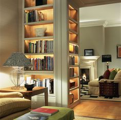 a living room filled with furniture and bookshelves