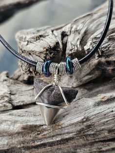 Peace River Find! This Shark Tooth Fossil is wrapped in silver tone wire with shimmering, multi color beads, green and purple. This is a hand sifted Tooth and hand wrapped item, placed on an 18 inch, black, Leather cord with lobster claw clasp. Second one down in the group picture. Thank you for looking! Silver Hand Wrapped Metal Necklace, Handmade Adjustable Silver-plated Wire Necklace, Silver Waxed Cord Necklace For Gift, Handmade Adjustable Silver Plated Wire Necklace, Adjustable Bohemian Necklace In Silver Plated Wire, Silver Necklace With Waxed Cord For Gift, Nickel-free Waxed Cord Necklace For Gifts, Nickel-free Waxed Cord Necklace - Ideal Gift, Wire Wrapped Jewelry On Waxed Cord As Gift