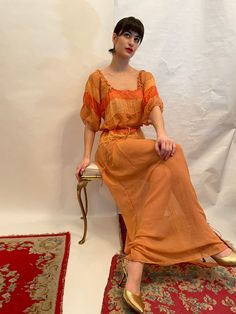 30's chiffon gown, with two tone orange colors, short sleeve dress, comes w/ chiffon cloth belt, square neckline. Shoulders 15, bust 16, waist 16, length 60, sleeve 6.5 Size M. good vintage condition Etsy Shipping Please read -Vintage and pre-owned items may have signs of wear and use and are offered as is. Traces of age and use are therefore completely normal and do not constitute defects. Please see pictures as they are part of the item description and refer to sizes/measurements provided. Ple Red Orange Brown Dress, Cheap Vintage Orange Dresses, Orange Selkie Dress, Retro Chiffon Dress, Orange Gown, Dress And Belt, 30s Fashion, Orange Outfit, Cloth Belt