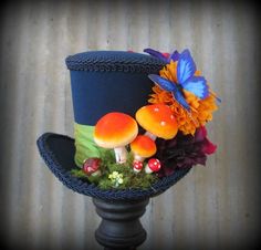 a top hat with mushrooms and flowers on it